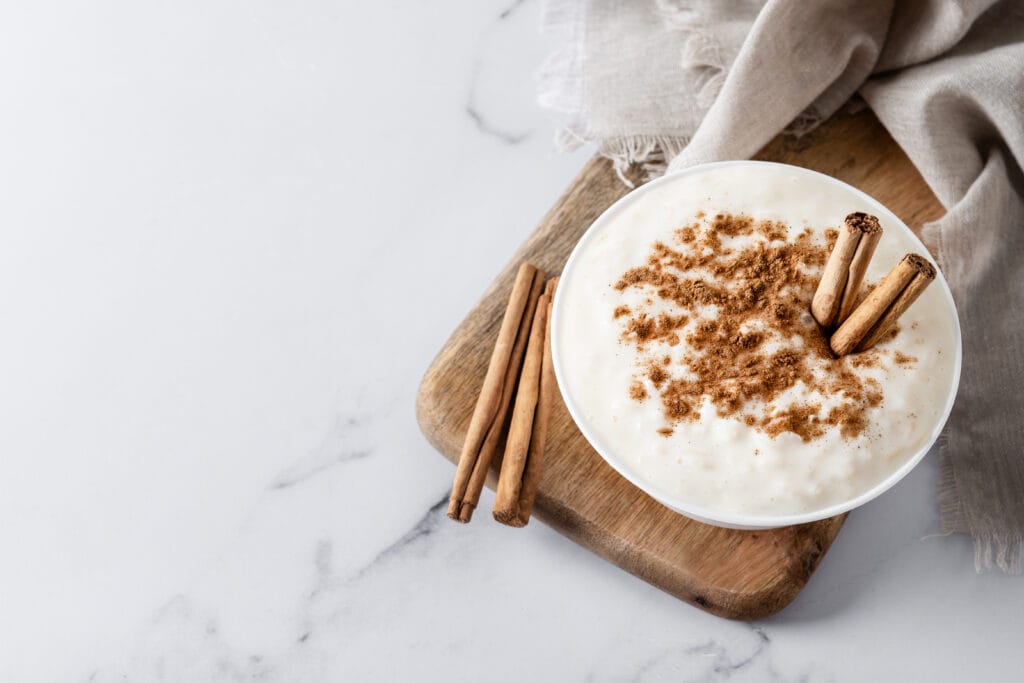 A creamy bowl of rice pudding topped with cinnamon and raisins.