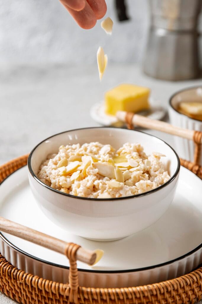 A creamy bowl of rice pudding topped with cinnamon and raisins.