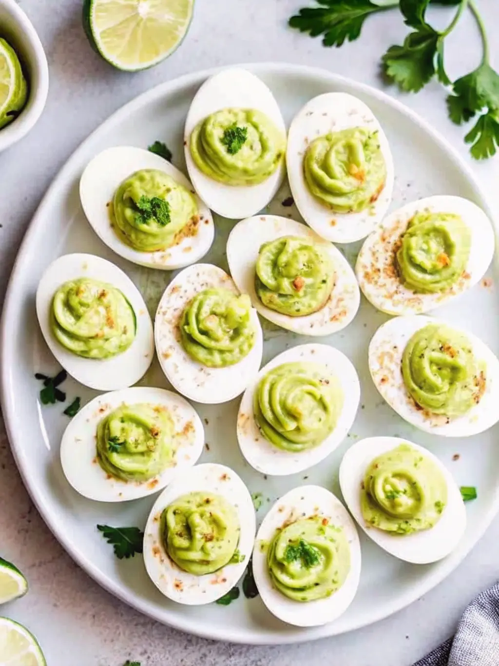 Mid-process shot focusing on the technique of piping the creamy, golden-yellow filling into the hollowed-out hard-boiled egg whites. A clear piping bag with a star tip is visible, gently swirling the filling. Several already filled 'Million Dollar Deviled Eggs' are on a blue-grey ceramic plate, waiting for their paprika and chive garnish. The scene is set on a marble countertop, illuminated by soft natural morning light, with warm tones and soft shadows. The overall feel is one of careful crafting and genuine love for cooking. 3:4 ratio. NO HANDS OR PEOPLE.